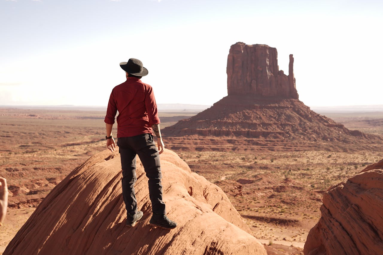 Lone traveler standing in awe of the scenic beauty of Monument Valley, Arizona.